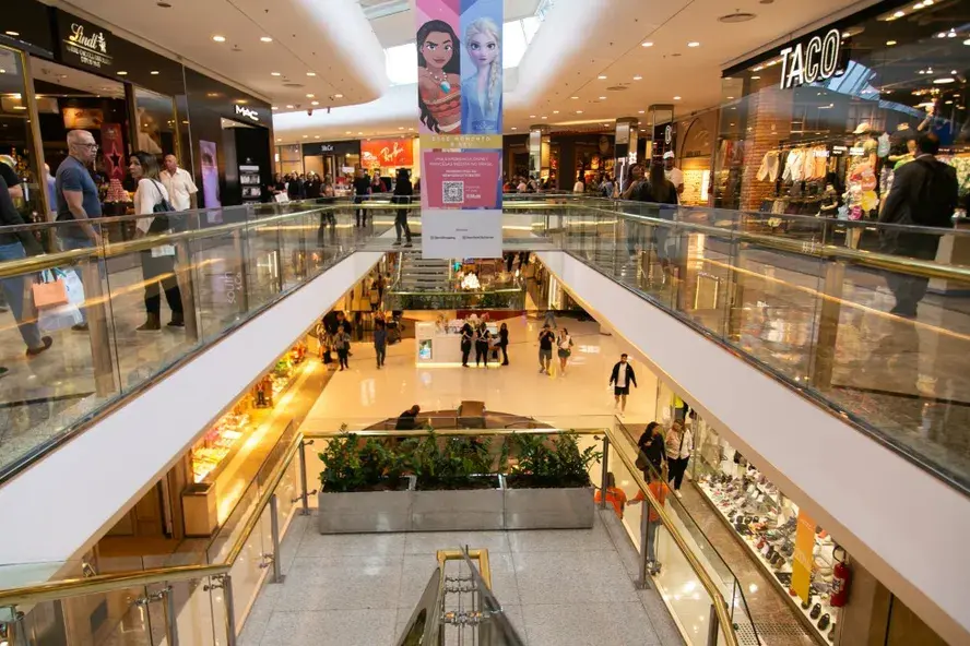 Interior de shopping center com corredores e lojas